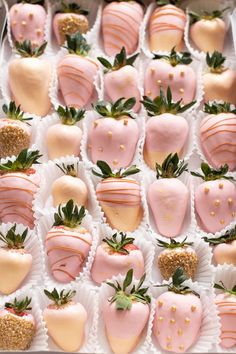 a box filled with lots of pink and white chocolate covered strawberries