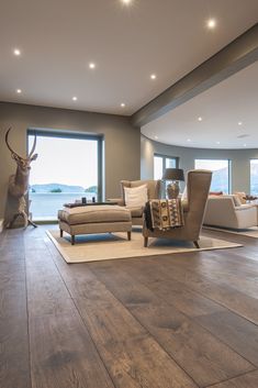 a living room with wooden floors and large windows