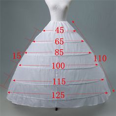 a white wedding dress on a mannequin with measurements for the bust and skirt