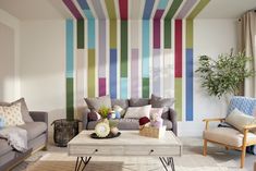 a living room filled with furniture and colorful striped walls