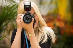 a woman taking a photo with her camera