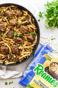 a skillet filled with pasta and meatballs next to a bag of pennella