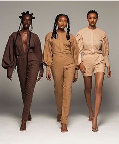 three models walking down the runway in brown outfits