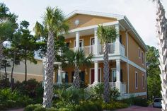 a house with palm trees in front of it