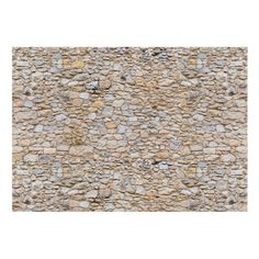 a stone wall with small rocks on it