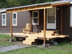 a small house with a porch and picnic table