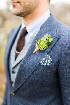 a man in a suit with a boutonniere on his lapel