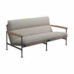 a couch with metal frame and wood arms