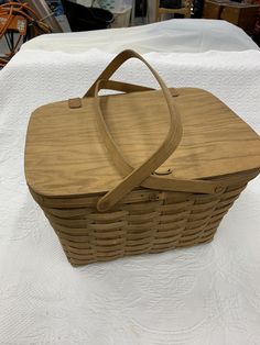 a wicker basket sitting on top of a white table