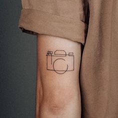 Tattoos For Filmmakers, Small Tattoos Photography, Photography Related Tattoos, Small Photography Tattoos, Minimalist Photography Tattoo, Camera Line Art Tattoo, Dainty Camera Tattoo, Photographer Tattoo Ideas For Men, Photography Tatoos Ideas