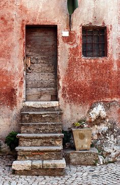 an old building with steps leading up to the door