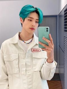 a person with blue hair taking a selfie