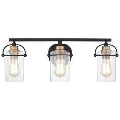 three light bathroom fixture with clear glass shades and bronze accents on an old - fashioned metal frame