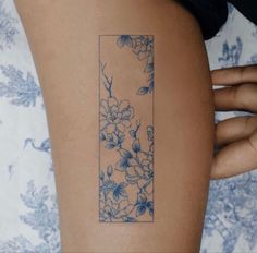 a woman with a tattoo on her arm has a blue and white flowered design