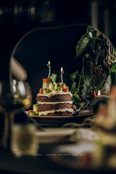 a cake with candles on it sitting on a table