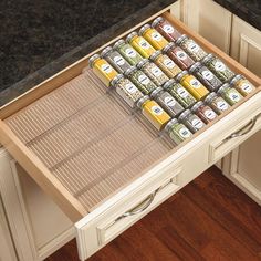 an organized spice drawer in a kitchen