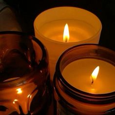 two candles sitting next to each other on a table