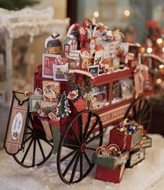 a red wagon filled with lots of christmas items on top of a snow covered ground