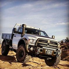 a white truck driving down a dirt road