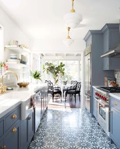 a kitchen with blue cabinets and white counter tops