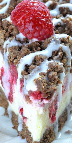 a close up of a piece of cake with strawberries on top and white icing