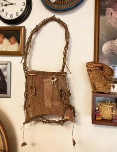 the wall is covered with pictures and other items, including an old purse hanging on it's side