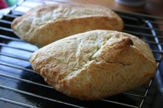 two loaves of bread cooling on a rack