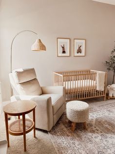 a baby's room with a crib, chair and ottoman