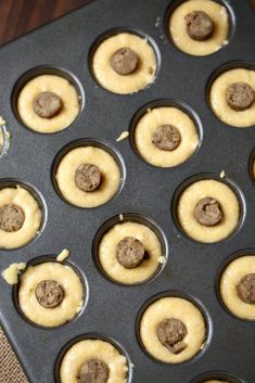 cupcakes with cookies in the middle on a baking tray ready to go into the oven