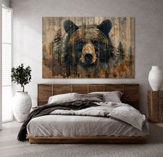 a large bear painting on the wall above a bed in a room with white walls