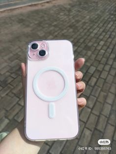 a person holding up a pink phone case with a magnifying glass on it