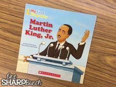 the book martin luther king jr is sitting on top of a wooden table with microphones