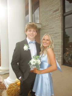 a young man and woman standing next to each other