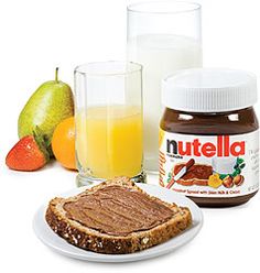 nutella peanut butter and jelly spread with fruit on the side, next to a glass of orange juice