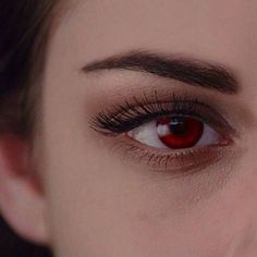 a woman's red eye with long lashes