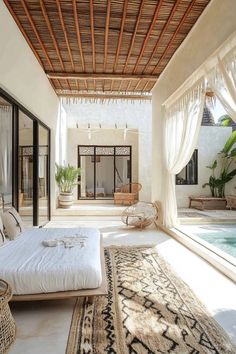 a bedroom with a large bed next to a swimming pool