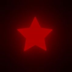 a large red star is lit up in the dark