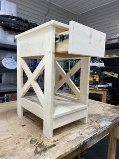 a wooden table with some unfinished furniture on it