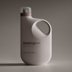 a bottle of detergent sitting on top of a white table next to a gray wall