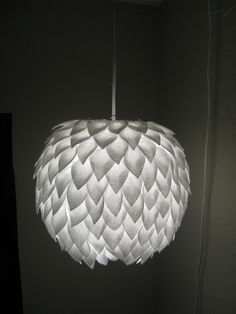 a white lamp hanging from a ceiling in a room