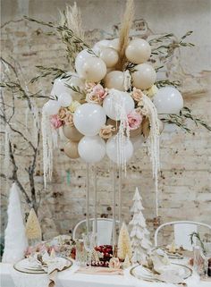 the table is set with balloons and flowers for an elegant winter themed dinner or bridal party