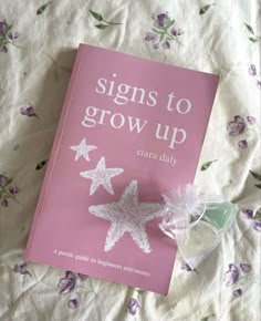 a pink book sitting on top of a bed