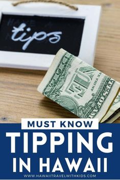 money sitting on top of a wooden table next to a sign that says must know tipping in hawaii