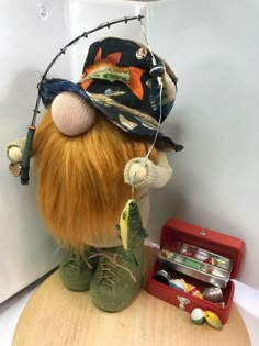 a stuffed animal wearing a hat and fishing gear