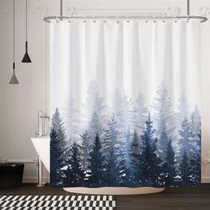 a bathroom with a shower curtain that has trees on it