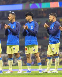 the soccer players are applauding each other on the field