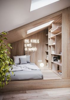 a bed sitting under a skylight in a bedroom next to a book shelf filled with books