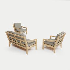 two chairs and a chair with armrests made out of wood