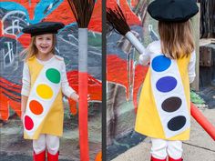 two girls dressed up in costumes with paintbrushes on their heads and one holding a broom