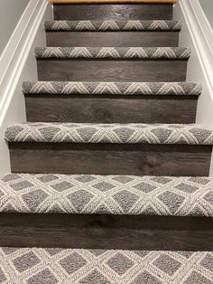 the carpeted stairs in this home are made from wood and have been painted gray